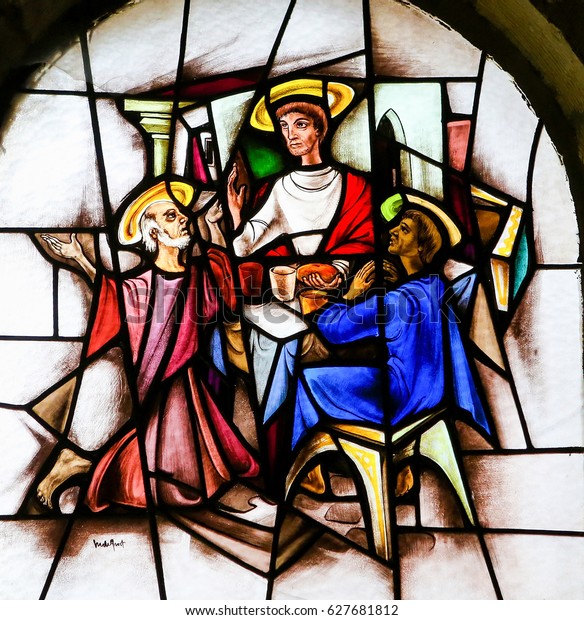 ANTWERP, BELGIUM - APRIL 22, 2017:\
Stained Glass window in the 15th Century Elzenveld Chapel in\
Antwerp, Belgium, depicting Jesus and two disciples at\
Emmaus