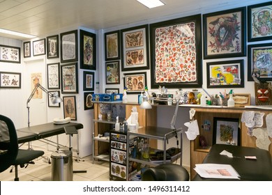 Antwerp, Belgium august 2017, A male tattoo artist making tattoo inside ink studio on blond woman