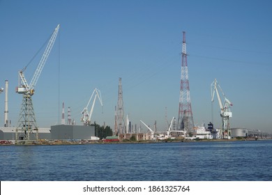 Antwerp, Belgium - August 6, 2018; Large harbor cranes on the banks of the port area of Antwerp