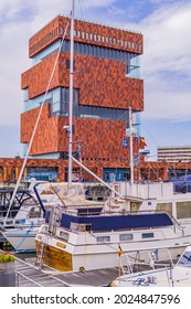 Antwerp, Belgium - August 8, 2021 - vertical view of the modern MAS (Museum aan de Stroom) with boats in the port