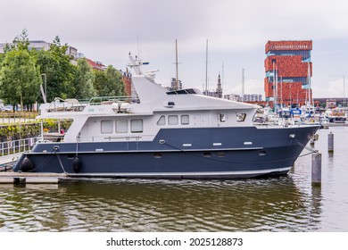 Antwerp, Belgium - August 8, 2021 - a yacht in the yacht port at Willemdok in Antwerp with MAS Museum in the background