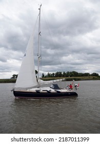 Antwerp, Belgium, July 31, 2022, woman driving a sailboat on the river Scheldt in Antwerp, Belgium
