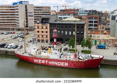 ANTWERP, BELGIUM - Jun 11, 2012: A red ship docked in the harbor of Antwerp on the Scheldt river, Belgium, Europe
