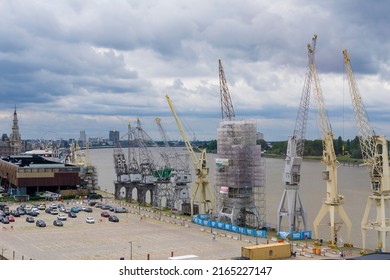 Antwerp, Belgium, June 2022: View on the historical harbor cranes on the Scheldt river in the city of Antwerp, Belgium