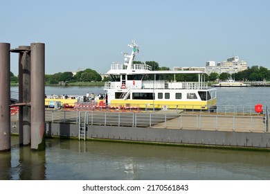 Antwerp city, Province Antwerp , Belgium - June 18, 2022: Scheldt river ferry Antwerpen city moored tour boat on the quay. White people some with bicycle waiting departure ship to cross river Scheldt
