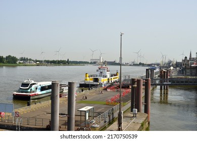 Antwerp city, Province Antwerp, Belgium - June 18, 2022: De Waterbus name in front of tour boat moored on the pier in front of a yellow ferry.