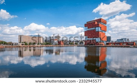 Antwerp skyline at port, Belgium. Panoramic view of buildings reflecting in the water near small Island District.