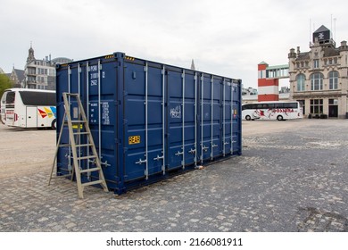 Antwerpen,  Belgium, April 2022. Blue shipping container  suitable to withstand shipment, storage, and handling along the Scheldt river in Antwerp, Belgium.