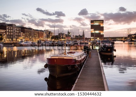 Antwerpen, Belgium, beautiful night view of modern Eilandje area and port. Small island district and sailing marine at sunset. Popular travel destination and tourist attraction