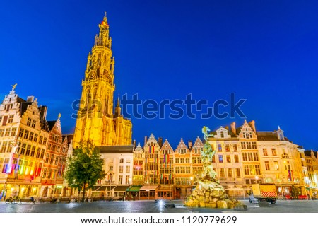 Antwerpen, Belgium. Night scene in downtown Antwerp, Belgium along the famous Meir Street and the lonely tower of the Cathedral of our Lady.