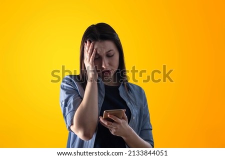 An anxcious shocked nervous scared woman reading message on his mobile phone,
