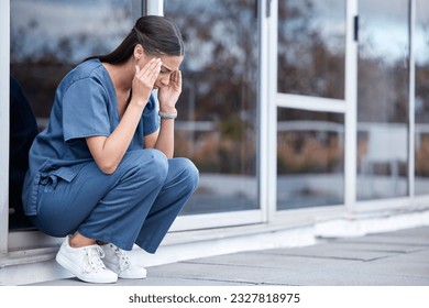 Anxiety, doctor or a woman with a headache from healthcare, surgery mistake or death at a hospital. Sad, depressed and a tired female nurse with a migraine or burnout from medical career at a clinic - Powered by Shutterstock