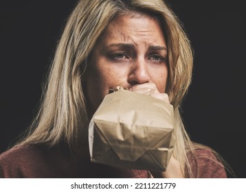 Anxiety, Nausea And Woman With Paper Bag For Stress And Panic Attack Relief With Black Mockup. Girl Suffering With Trauma, Psychosis And Mental Health Trouble Breath Technique For Calm Mindset.