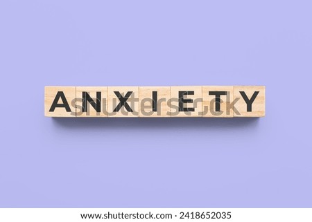 anxiety wooden cubes on purple background