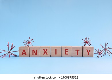 Anxiety Word In Wooden Blocks On Blue Background. Coping With Anxiety, Stress, Ptsd And Depression During Covid-19 Pandemic Concept.