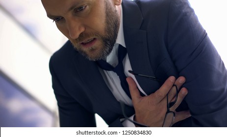 Anxious business man feeling chest pain, overworked manager, heart attack