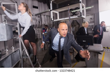 Anxious businessman running in escape room on background with his coworkers. Ambition and motivation concept