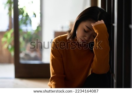 Anxious and depressed Asian woman