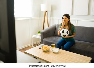 Anxious Female Sports Fan Biting Her Nails While Watching The National Soccer Team Playing A Game On Tv