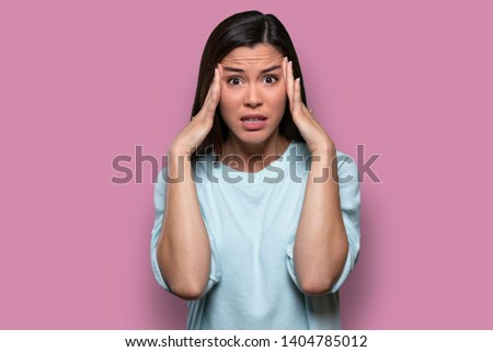 Anxious female worried and concerned, having inner conflict, stress, anxiety, isolated on pink background