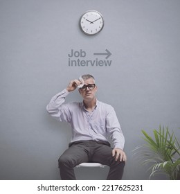 Anxious Job Candidate Waiting For The Interview, He Is Sweating And Feeling Panicked