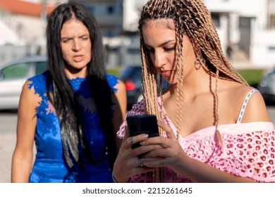 Anxious Mother Control  Her Teen Girl  Obsessed Addicted To Internet And Social Media, Cellphone Usage.Teen Ignoring Her Mom While Looking At Her Phone Or While Texting Messages