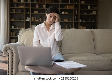 Anxious Unhappy Young Hispanic Woman Looking At Laptop Screen, Feeling Stressed Doing Financial Paperwork, Making Mistakes Paying Bills Taxes Online, Suffering From Lack Of Money, Bankruptcy Concept.