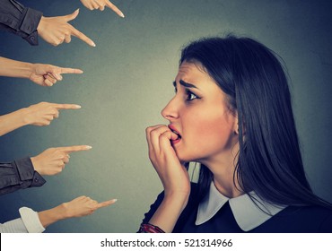 Anxious woman judged by different hands. Concept of accusation of guilty girl. Negative human emotions face expression feeling  
