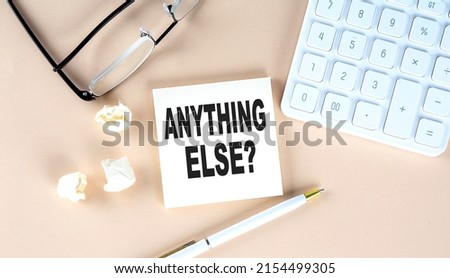 Anything Else question text on sticky with pen ,calculator and glasses on beige background