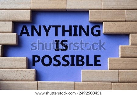 Anything is Possible symbol. Wooden blocks with words Anything is Possible. Beautiful purple background. Business and Anything is Possible concept. Copy space.