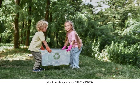 Anything that can be recycled. Two cute little boy and girl holding recycle bin with plastic waste while standing in the forest or park. Environmental conservation and ecology concept - Powered by Shutterstock