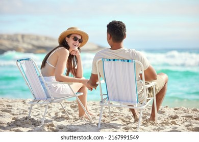 Anywhere with you is a magical time. Shot of a young couple relaxing at the beach.