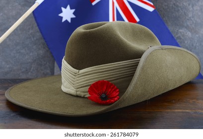 Anzac army slouch hat with Australian Flag on vintage wood background.