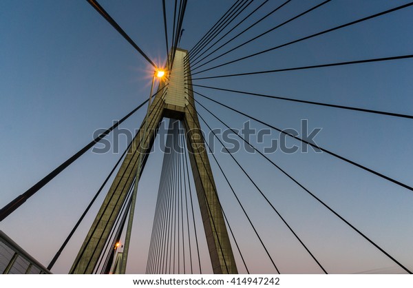 ANZAC Bridge pylon with steel cables against sunset\
sky, Sydney, Australia. ANZAC Bridge is the longest cable-stayed\
bridge in Australia, and amongst the longest in the world.\
Bottom-up view