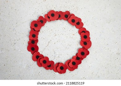 Anzac day. Australian and New Zealand national public holiday or Remembrance day. Red poppies wreath on biege stone background