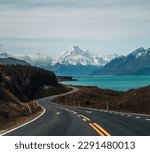 Aoraki Mount Cook, road and turquoise lake Pukaki view from Peter s Lookout, South Island, New Zealand. Warm colours, clear sky, snowy mountain tops. Iconic scenic New Zealand photo.