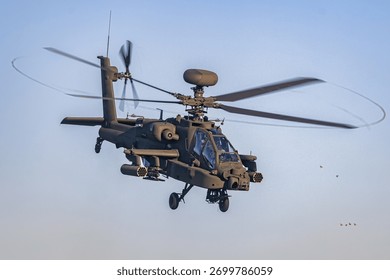 Apache Attack Helicopter In Flight Showcasing Weaponry