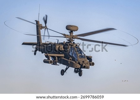 Apache Attack Helicopter In Flight Showcasing Weaponry