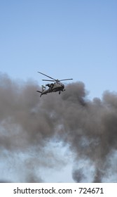 Apache helicopter in flight in a war zone