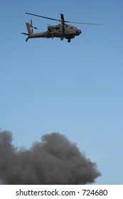 Apache helicopter in flight in a war zone