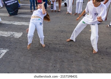 APARECIDA DE GOIÂNIA GO BRAZIL - MAY 15 2022: A group of people demonstrating the capoeira fight in the Procession of Pretos Velhos in the city of Aparecida de Goiania.