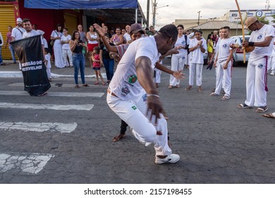 APARECIDA DE GOIÂNIA GO BRAZIL - MAY 15 2022: A group of people demonstrating the capoeira fight in the Procession of Pretos Velhos in the city of Aparecida de Goiania.