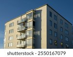 Apartment building with balconies, blue sky