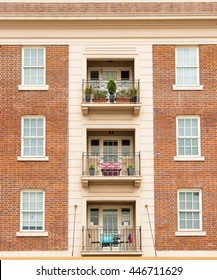 Apartment Building Exterior Wall Red Brick Symmetrical Architecture With Windows And Balconies In Three.