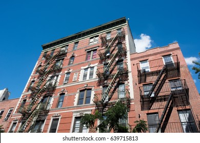 Apartment Building With Fire Escape On The Exterior.  