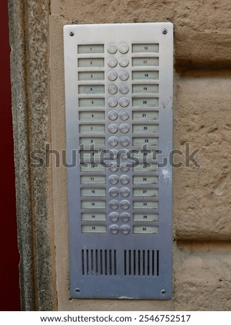 apartment building intercom system with 30 buttons to call apartments numbered without names