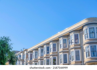 Apartment Buildings With Decorative Frieze And Dentils In San Francisco, California. Apartment Building Exterior With Curved Walls On The Right Side And Bay Windows At The Front.