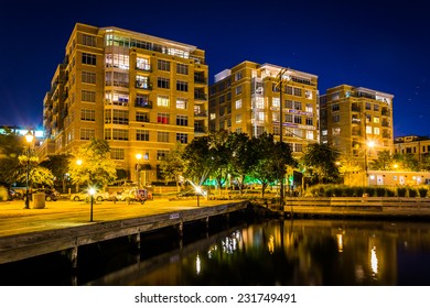 Apartment buildings at night on the waterfront in Fells Point, Baltimore, Maryland.