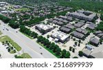 Apartment complex in mixed-use development area along Keller Parkway, Farm to Market Road 1709 with commercial building, restaurants, residential houses in Keller, Texas, suburbs Dallas, aerial. USA