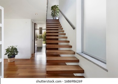 Apartment entrance hall with wooden staircase access to upper floor, design, furniture, home, modern, sea, wooden - Shutterstock ID 1686986269